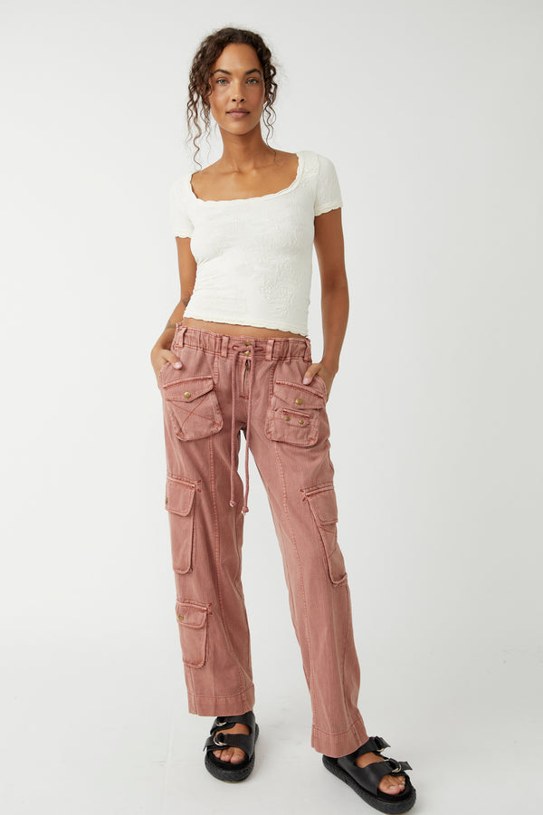 front view of model wearing the tahiti cargo pants. shows the drawstring closure. also shows the multiple pockets, the low rise and the slouchy fit. 