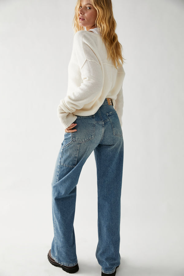 back view of model in jeans. shows the back pockets, and carpenter detailing. shows the baggy leg and long length.