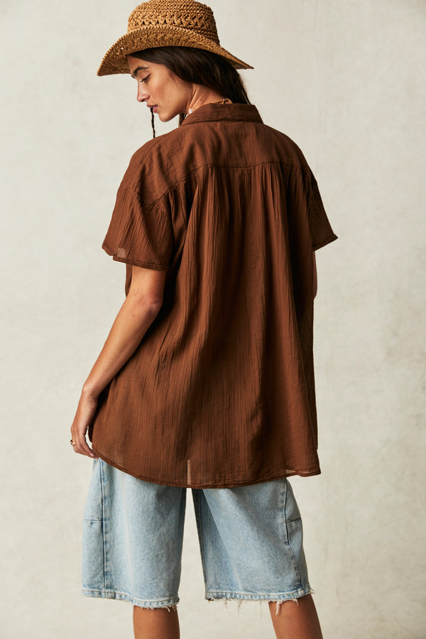 back view of the model wearing the float away shirt. shows the dropped shoulders. also shows the oversized fit, the classic collar and the defined seaming. 