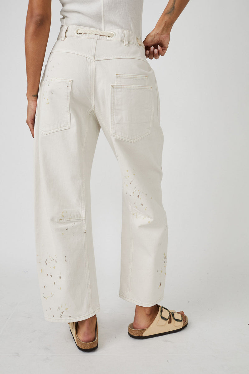 back view of model in pants. shows the wide leg, back pockets and paint splatter.