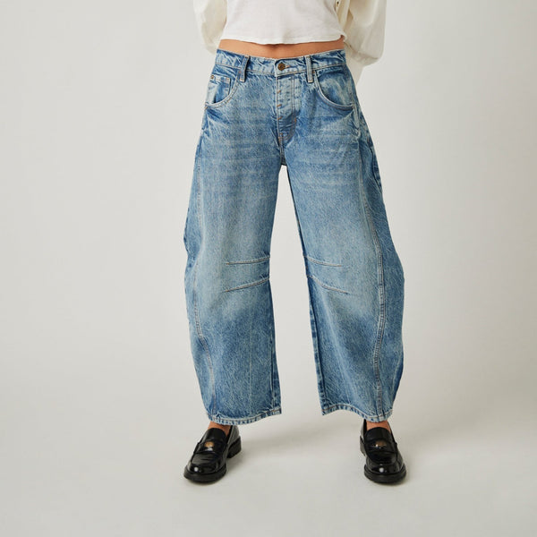 front view of the model wearing the good luck mid rise barrel pant. shows the mid rise of the pant. also shows the slouchy, relaxed fit, the ankle length, and the tapered bottom hem. 