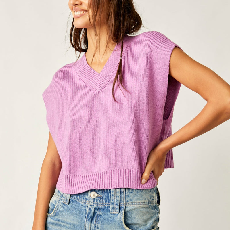 front view of model wearing the easy street vesy in beauty berry. shows the v neckline. also shows the dropped armholes, the ribbed hem and relaxed fit. 