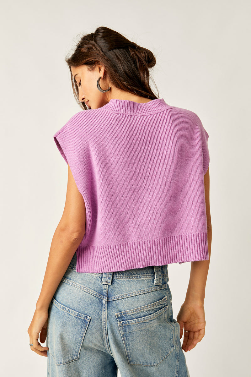 back view of model wearing easy street vest in beauty berry. show the dropped armholes. alslo shows the tiny side slits and the ribbed hems. 