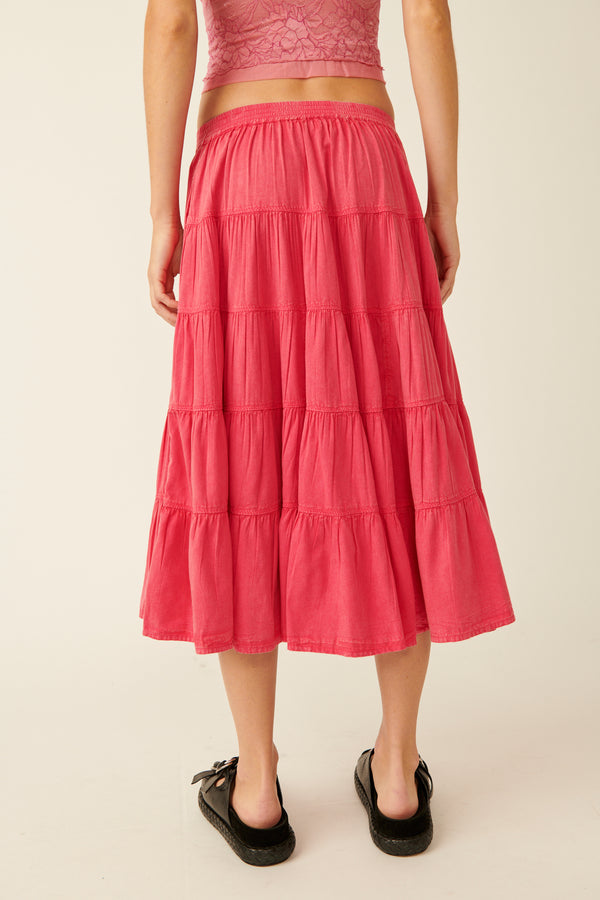 back view of the model wearing the in full swing midi skirt. shows the tiered  design. also shows the a line hem, the low rise and the midi length.