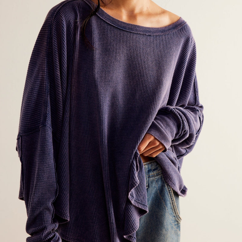 Front view of model wearing thermal. Shows the wide scoop neckline. Also shows the exposed seaming and dropped shoulders.