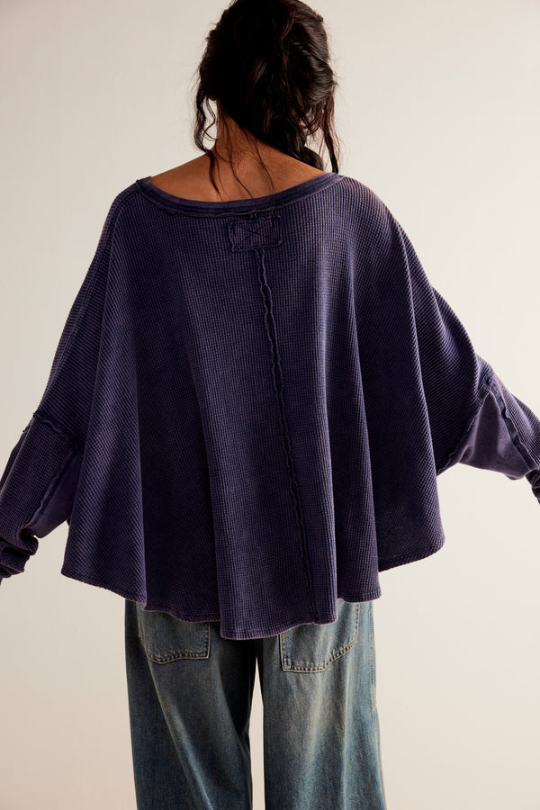Back view of model wearing thermal. Shows the the oversized, slouchy fit. Also shows the wide scoop neckline and the round bottom hem. 