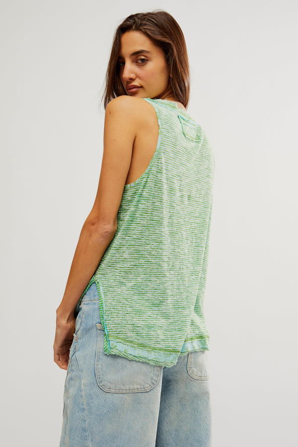back view of the model wearing the love language tank. shows the side slits. also shows the raw hems and the defined seaming throughout. 