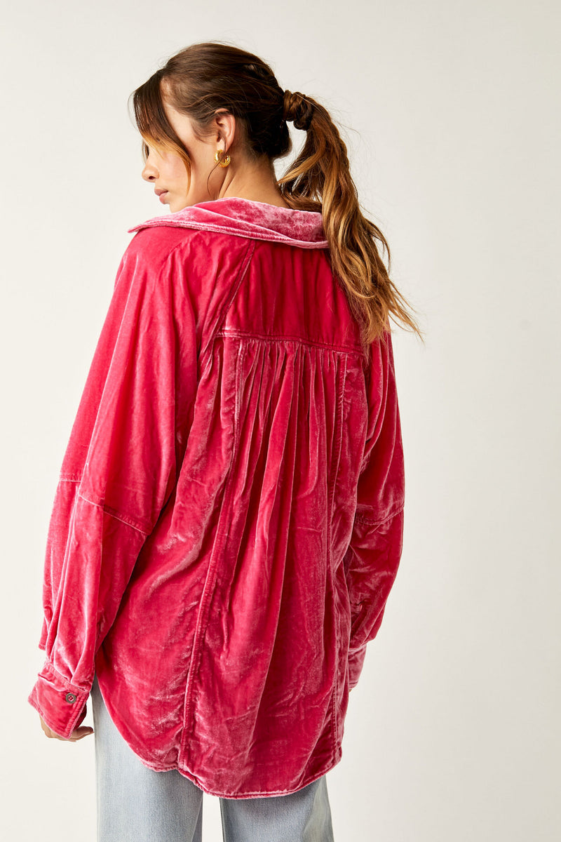Back view of model wearing the top. Shows the defined hemming throughout the back.  Also shows the drop shoulders, rounded hemline and this beautiful bright pink color. 
