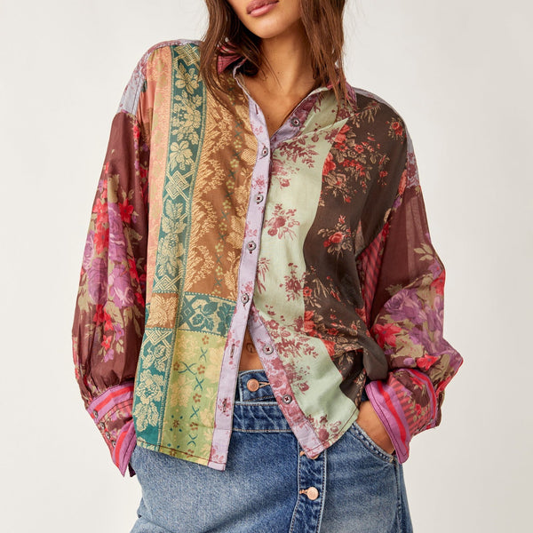 front view of the model wearing the flower patch top. shows the classic collar. also shows the front button down closure, the dropped shoulders and the different floral patchwork throughout. 