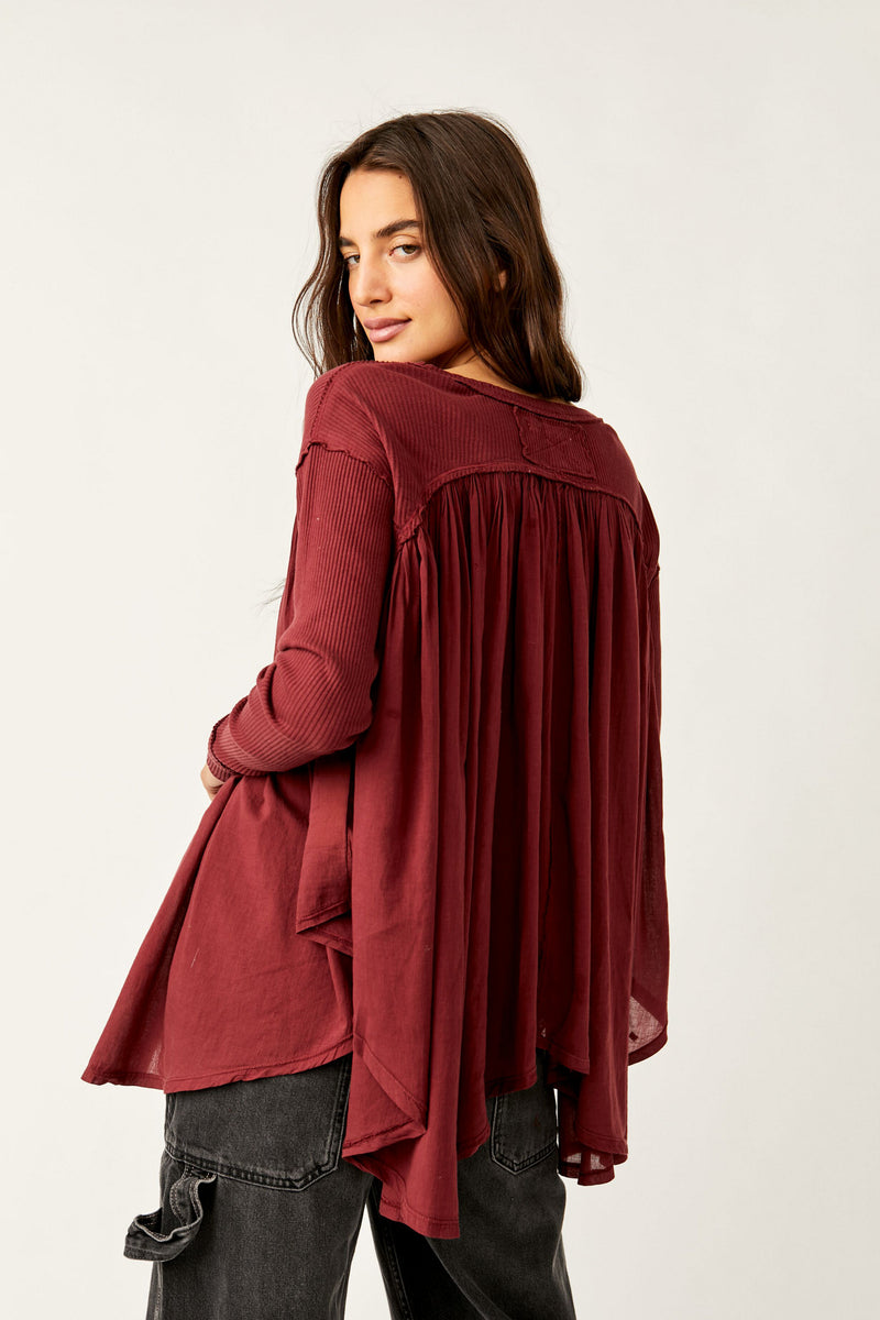 Back view of the model wearing top. Show the ribbing throughout the sleeves and the upper back. Also shows the handkerchief bottom hem and shows the beautiful red/wine color called mulberries.  