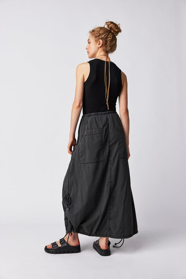 back view of the model wearing the picture perfect parachute skirt. shows the back dropped patch pockets. also shows the elastic drawstring at the bottom and the slouchy fit. 