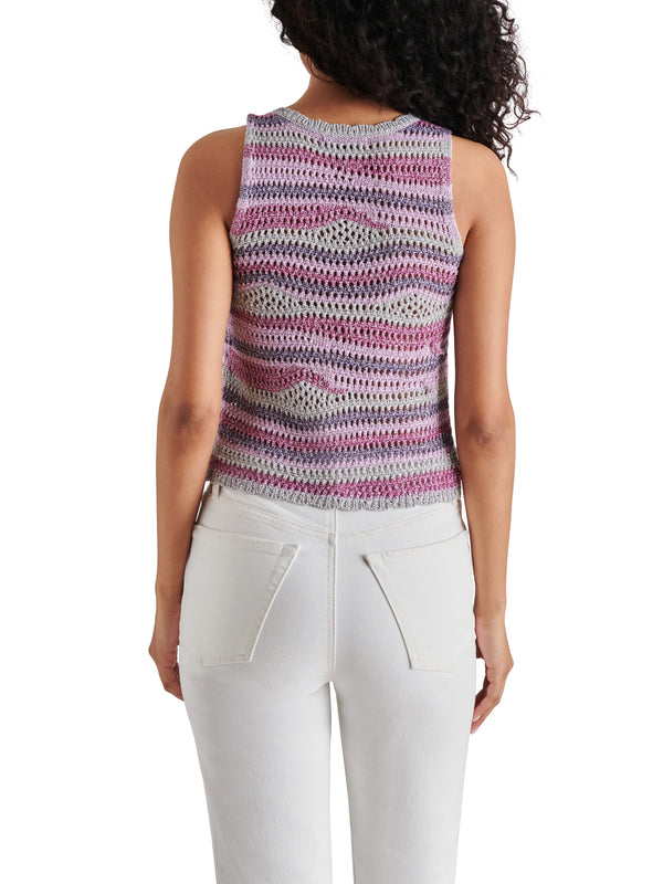 back view of the model wearing the hannah sweater. shows the knit detailing. also shows that the sweater is sleeveless and the fitted style. 