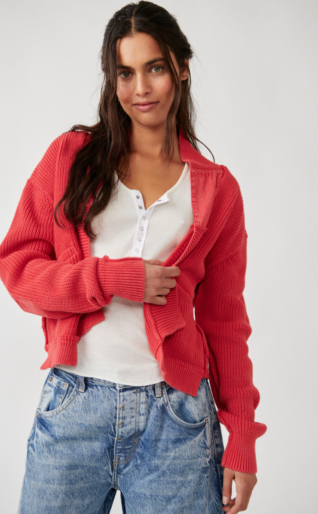 model wears cardigan open over white henley with acid wash jeans