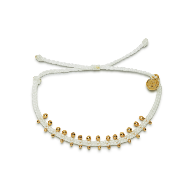 White mini braided bracelet with gold metal beads. Has adjustable string visible.