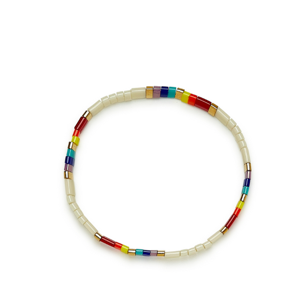 Stretch bracelet on flat surface. Shows multi colored flat beads.