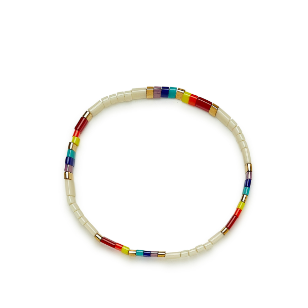 Stretch bracelet on flat surface. Shows multi colored flat beads.