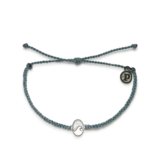 A mini braid, wax coated string bracelet. Adjustable pull strings. Featuring an oval charm with wave in center. Also features a mini circle charm with letter "P".