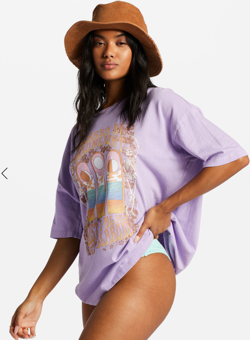 side view of model styles tee with a bucket hat and bathing suit bottoms