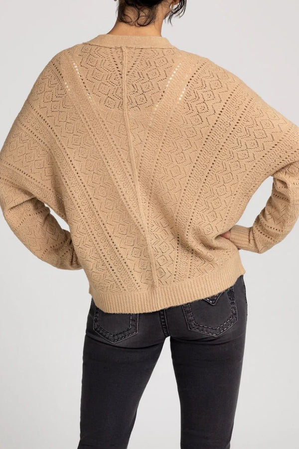 Beige knitted sweater with geometric pattern on a plain background