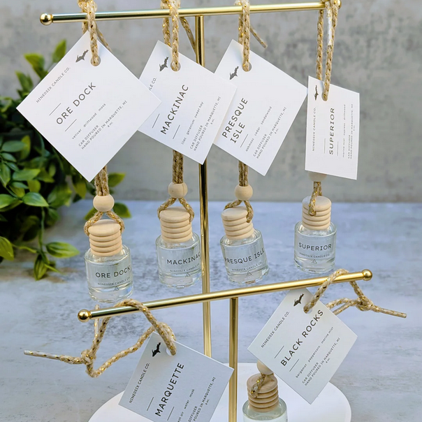 display filled with small hanging jars of car diffusers