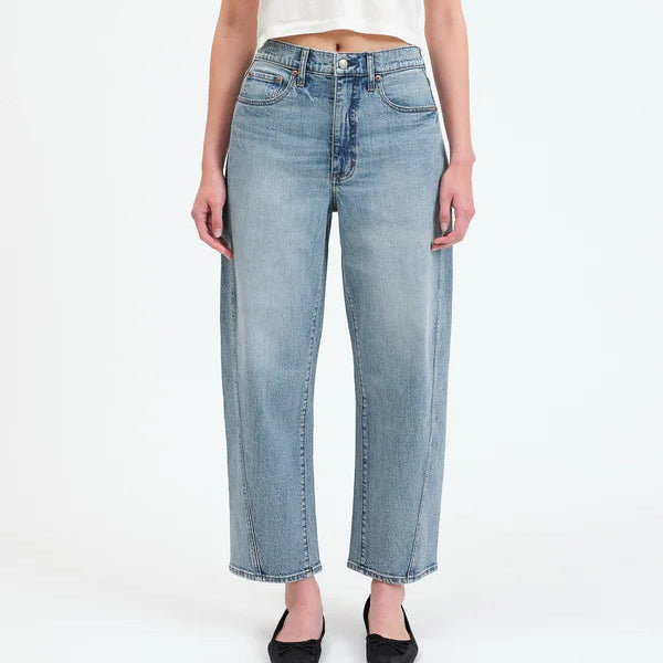 Person wearing a white t-shirt and light blue jeans on a white background