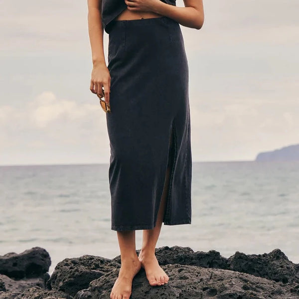 shows front view of model in skirt. shows the high waist, mineral wash, side slit and ankle length.