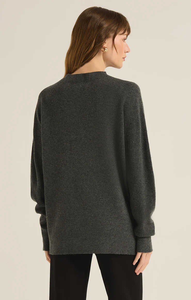 back view of the model wearing the gia crew neck sweater. shows the longer length. also shows the oversized fit, the crew neckline and the ribbed detailing. 