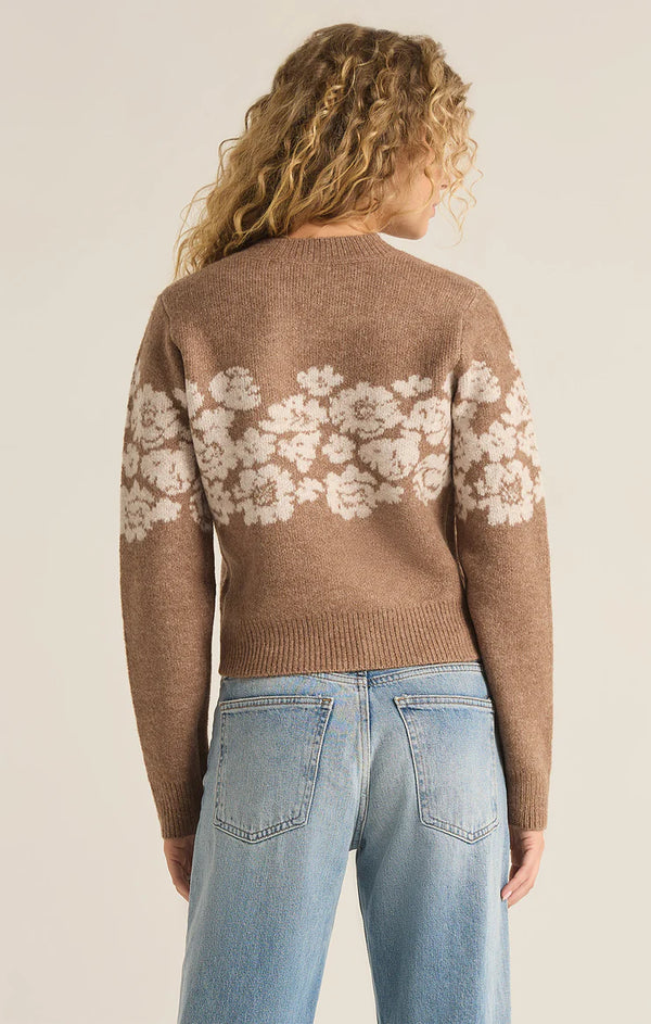 back view of the model wearing the marisol flora sweater. shows the ribbed detailing. also shows the crew neckline, the fitted style and the floral pattern. 