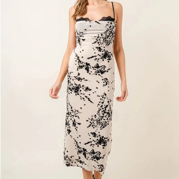 front view of the model wearing the vanessa velvet floral mesh midi dress. shows the thin adjustable spaghetti straps. also shows the peak boo lace bra detail, the midi length and the cowl neckline. 