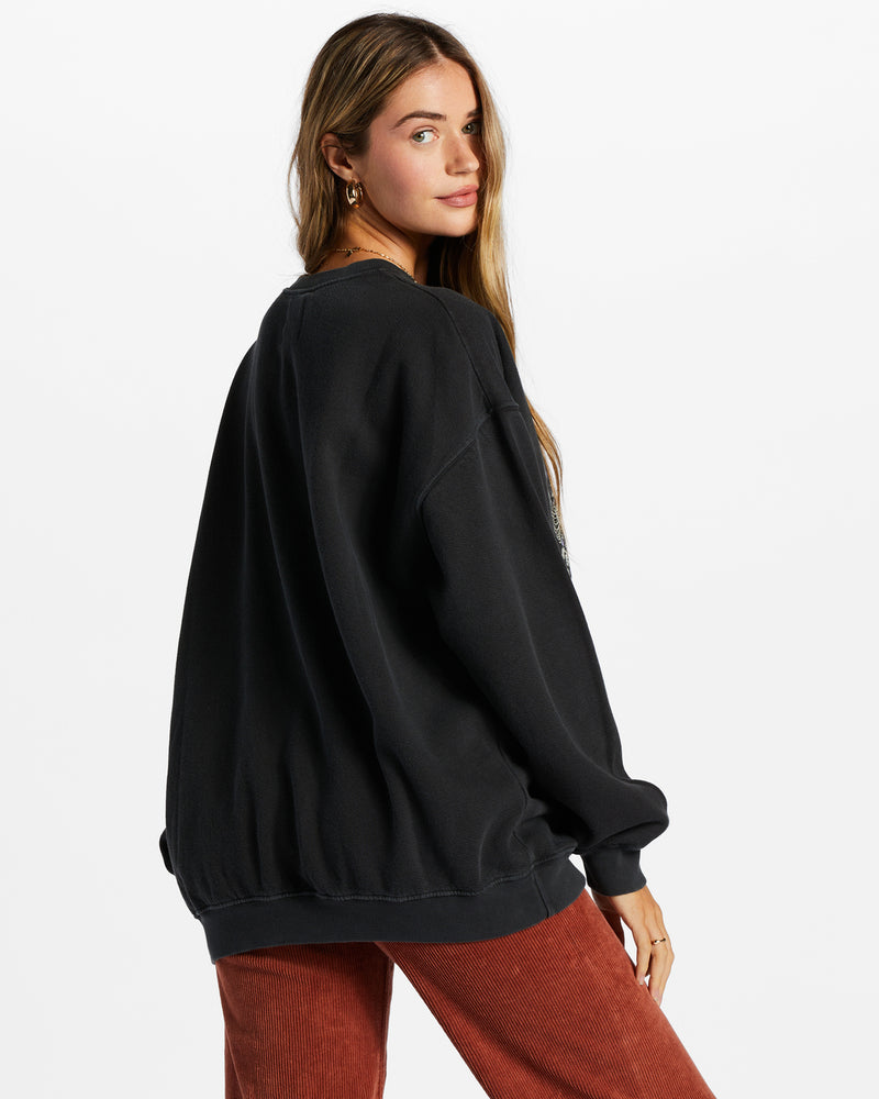 back view of model in sweatshirt. shows the dropped shoulders and oversized fit.