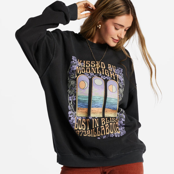 front view of model in sweatshirt. shows the dropped shoulders, crew neckline, graphic design across the front and fitted cuffs and hem.