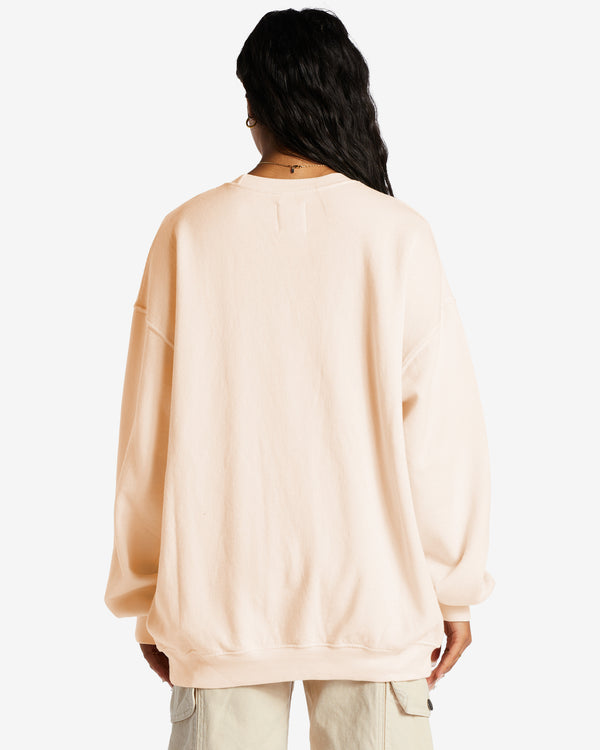 back view of model in sweatshirt. shows oversized fit and dropped shoulders.