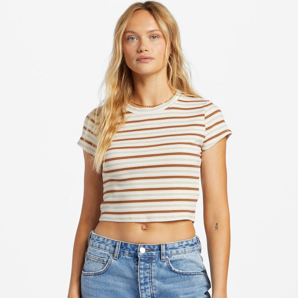 front view of model wearing the easy does it top. shows the crew neckline. also shows the cap sleeves, the multi colored stripes, and the crop length of the top. 