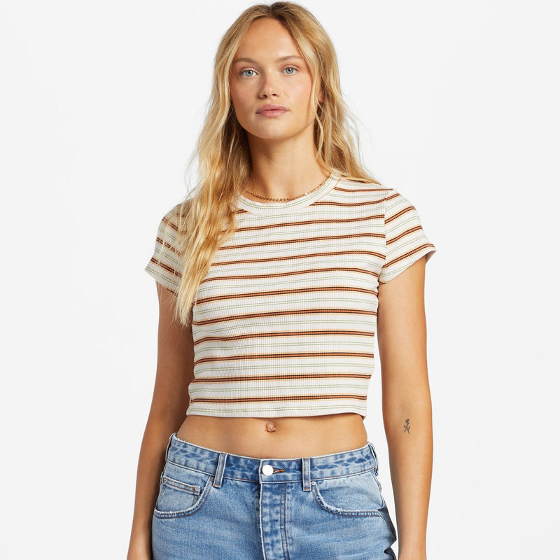 front view of model wearing the easy does it top. shows the crew neckline. also shows the cap sleeves, the multi colored stripes, and the crop length of the top. 