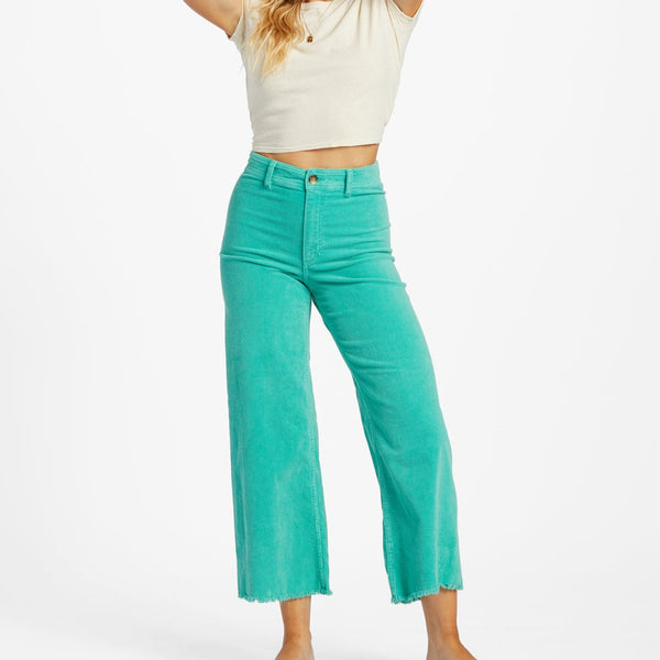 front view of model wearing the free fall wide leg cord pant. shows the wide leg. also shows the bottom raw hem, the button closure, and the corduroy detailing.  