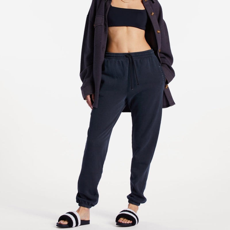 front view of model in sweatpants. shows the high waist with elastic drawstring waistband and elastic ankle cuffs.