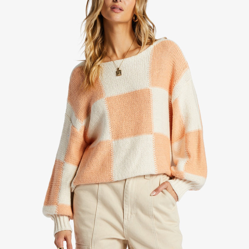 front view of model in sweater. shows the boat neckline, relaxed fit, long puff sleeves with a fitted cuff and dropped shoulders. you can see the relaxed fit.