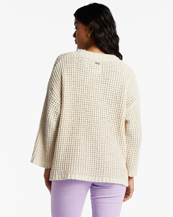 back view of model in sweater. shows the dropped shoulders, and relaxed fit.