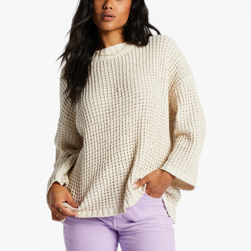 front view of model in sweater. you can see the relaxed fit, open knit fabrication, and dropped shoulders.