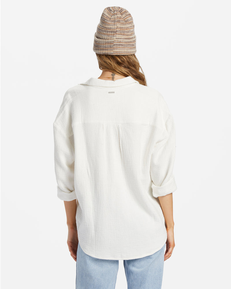 shows back view of model in shirt. the dropped shoulders are visible as well as a horizontal seam across the back.