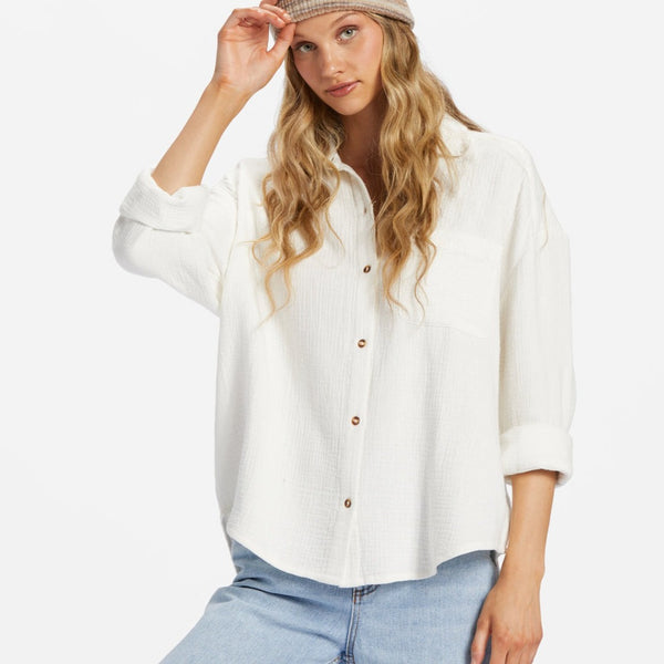 shows front view of model in shirt. shows buttons down the front, collared neckline, and gauzy material.