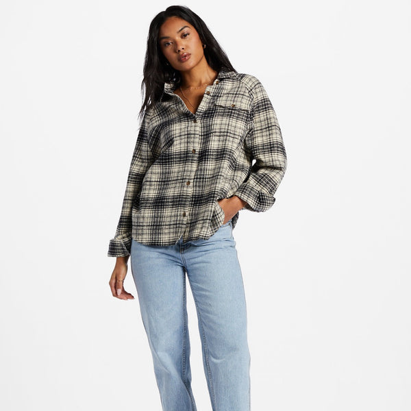 front view of model in flannel. shows oversized fit, front patch pocket on front, and buttons down the front.