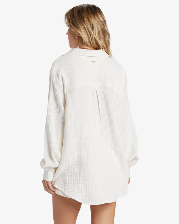 back view of the model wearing the swell woven shirt. shows the dropped shoulders. also shows the oversized fit and the collared neckline. 