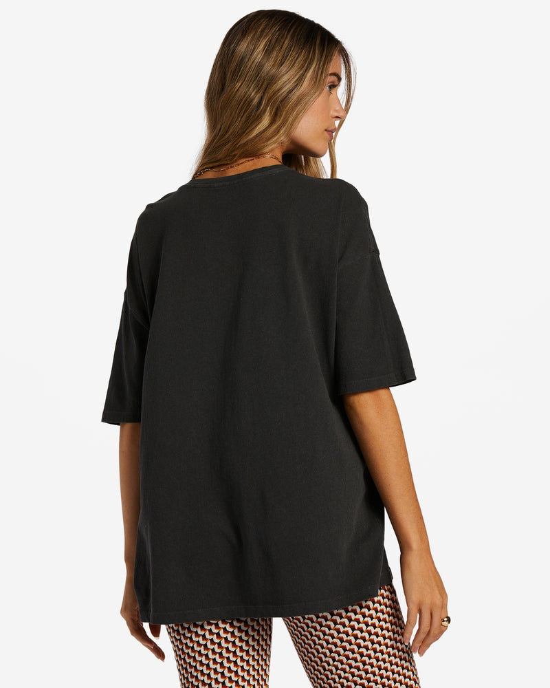 back view of model in t-shirts. shows the plain black back and dropped shoulders.