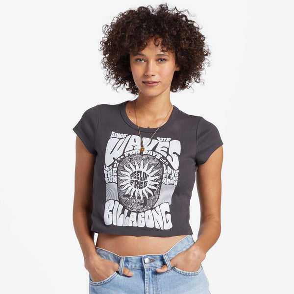 front view of model wearing the live by the sea tee. shows the loose crew neckline. also shows the top is cropped and the screen print on the front of the tee. 