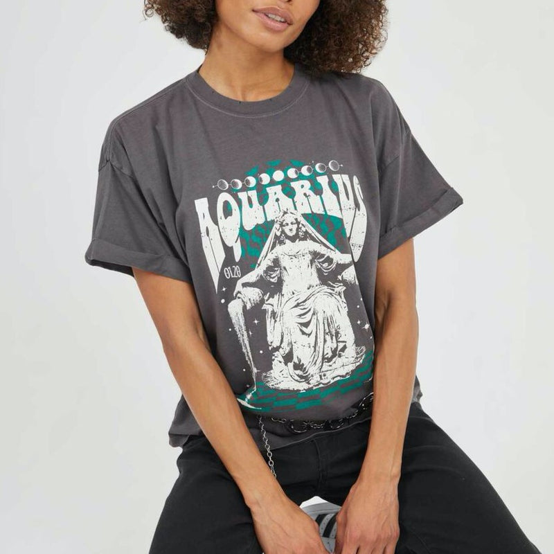 Front view of model wearing tee. Shows the crew neckline. Also shows the cuff sleeves, distressing on neckline and the Aquarius zodiac graphic. 