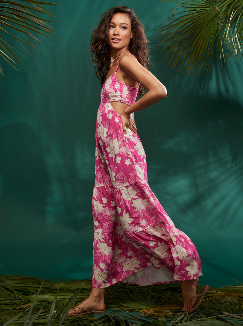 Side view of maxi dress. Showcases the cutout ribcage detail and flowy bottom. Hits model at mid ankle.