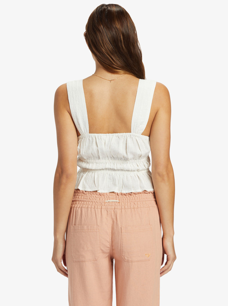 back view of the model wearing the sunset mist woven shirt. shows the wide straps. also shows the rouched body, the cropped length and the square neckline. 