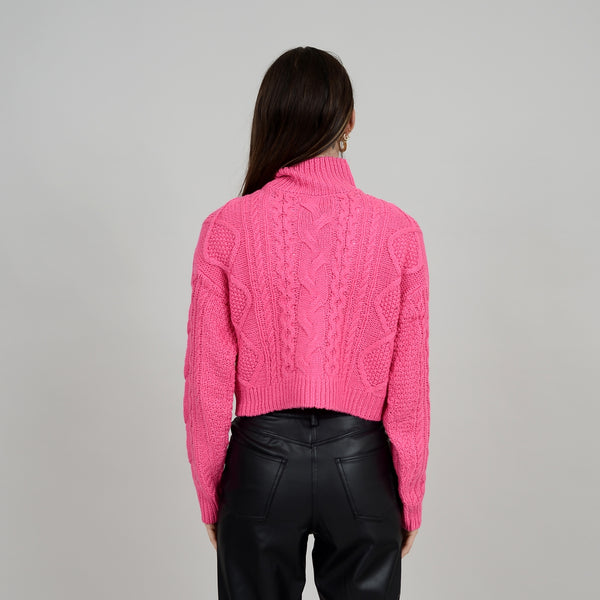 Back view of model wearing Erin crop. Shows that back is slightly more cropped than front. Also shows the turtle neck and long sleeves. 