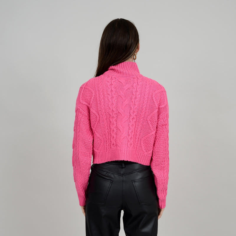 Back view of model wearing Erin crop. Shows that back is slightly more cropped than front. Also shows the turtle neck and long sleeves. 